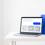 A laptop on a white desk showing sneaker recommendations in an AI chat, next to a blue shopping bag.
